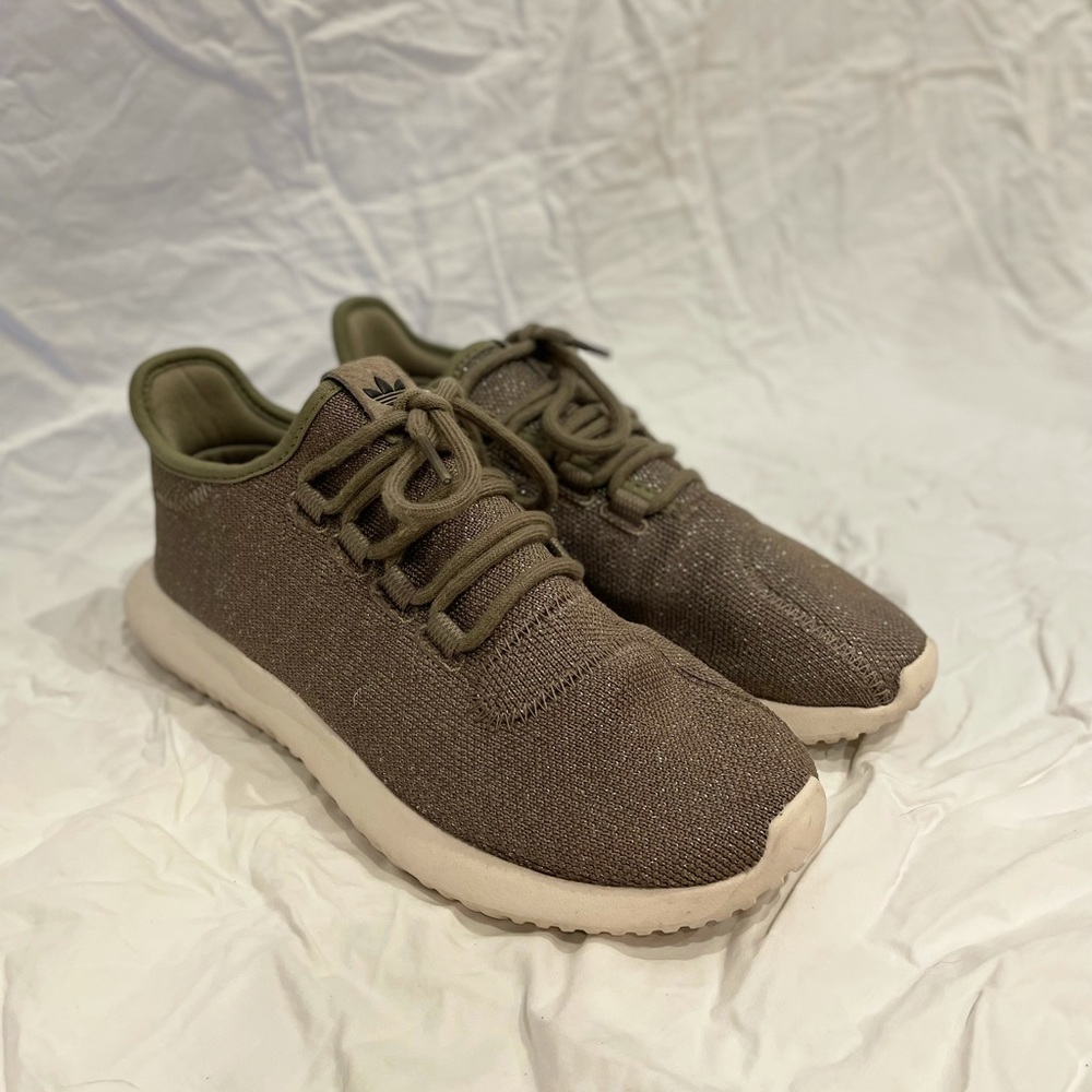 ADIDAS green sneakers.